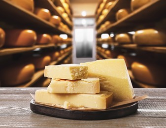 Delicious parmesan cheese on wooden table in warehouse