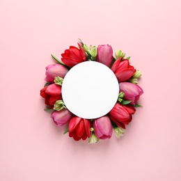 Photo of Beautiful composition with spring flowers and blank card on color background, top view. Space for text