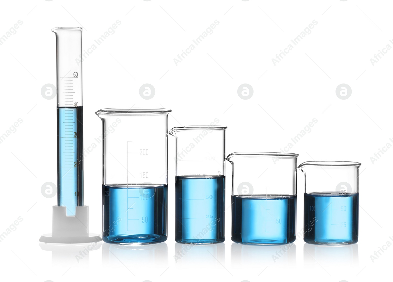 Photo of Laboratory glassware with blue liquid isolated on white