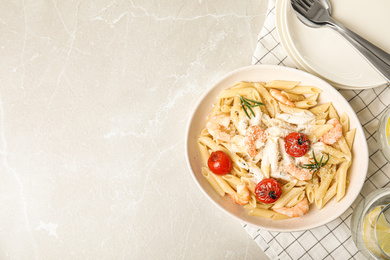 Delicious pasta with shrimps on marble table, flat lay. Space for text