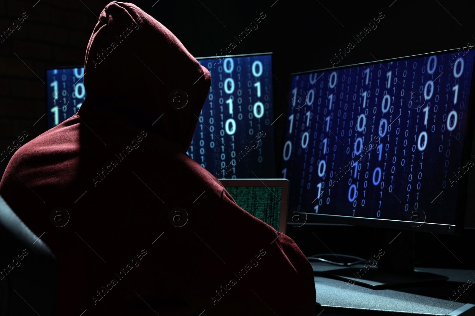 Photo of Hacker working with computers in dark room. Cyber attack