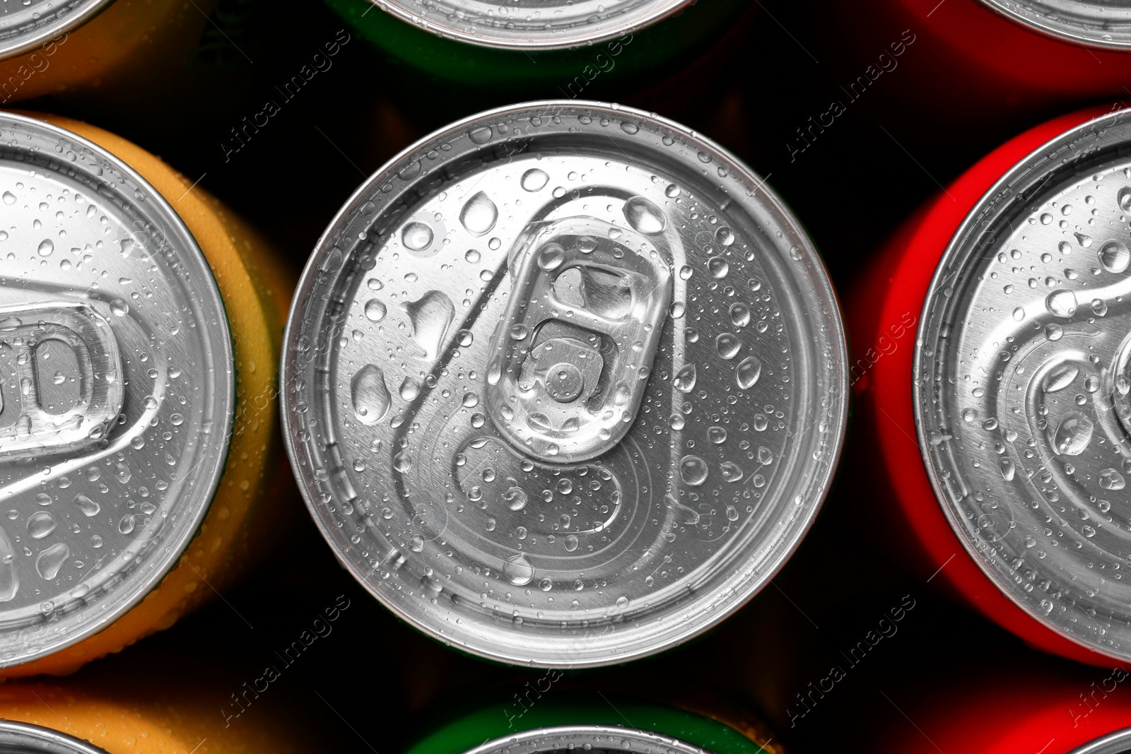 Photo of Energy drinks in wet cans, top view. Functional beverage