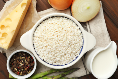 Photo of Flat lay composition with different ingredients on wooden table. Risotto recipe