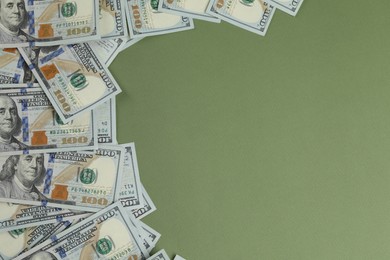 Photo of Money exchange. Dollar banknotes on green background, top view. Space for text