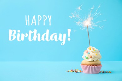 Image of Happy Birthday! Delicious cupcake with sparkler on light blue background