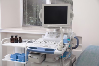Photo of Ultrasound machine and medical trolley in hospital