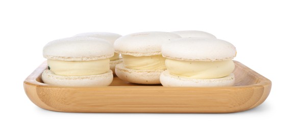 Photo of Delicious sweet macarons in wooden plate isolated on white