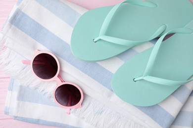 Photo of Beach objects on pink wooden background, flat lay