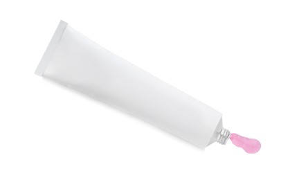 Open tube with ointment on white background, top view
