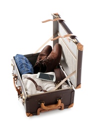 Photo of Packed suitcase with warm clothes and smartphone on white background. Space for text