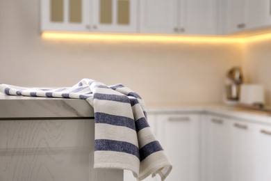 Photo of Kitchen towel on white table indoors, space for text