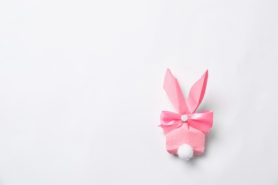 Photo of Creative Easter bunny gift bag on white background, top view