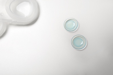 Photo of Contact lenses on light background, top view