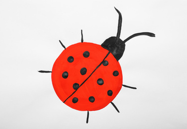 Photo of Child's painting of ladybug on white paper