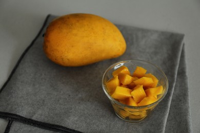 Photo of Delicious cut and whole mangoes on light table