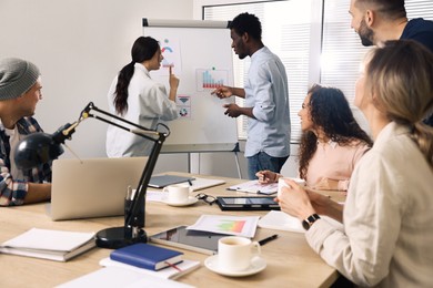 Photo of Team of employees working together in office. Startup project