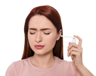 Photo of Woman using ear spray on white background