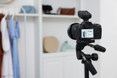 Photo of Fashion blogger's workplace. Stylish clothes and accessories indoors, focus on camera