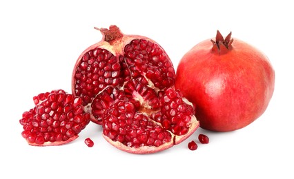 Photo of Half and whole pomegranates isolated on white