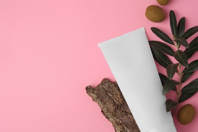 Photo of Natural cosmetic. Flat lay composition with olive cream on pink background. Space for text