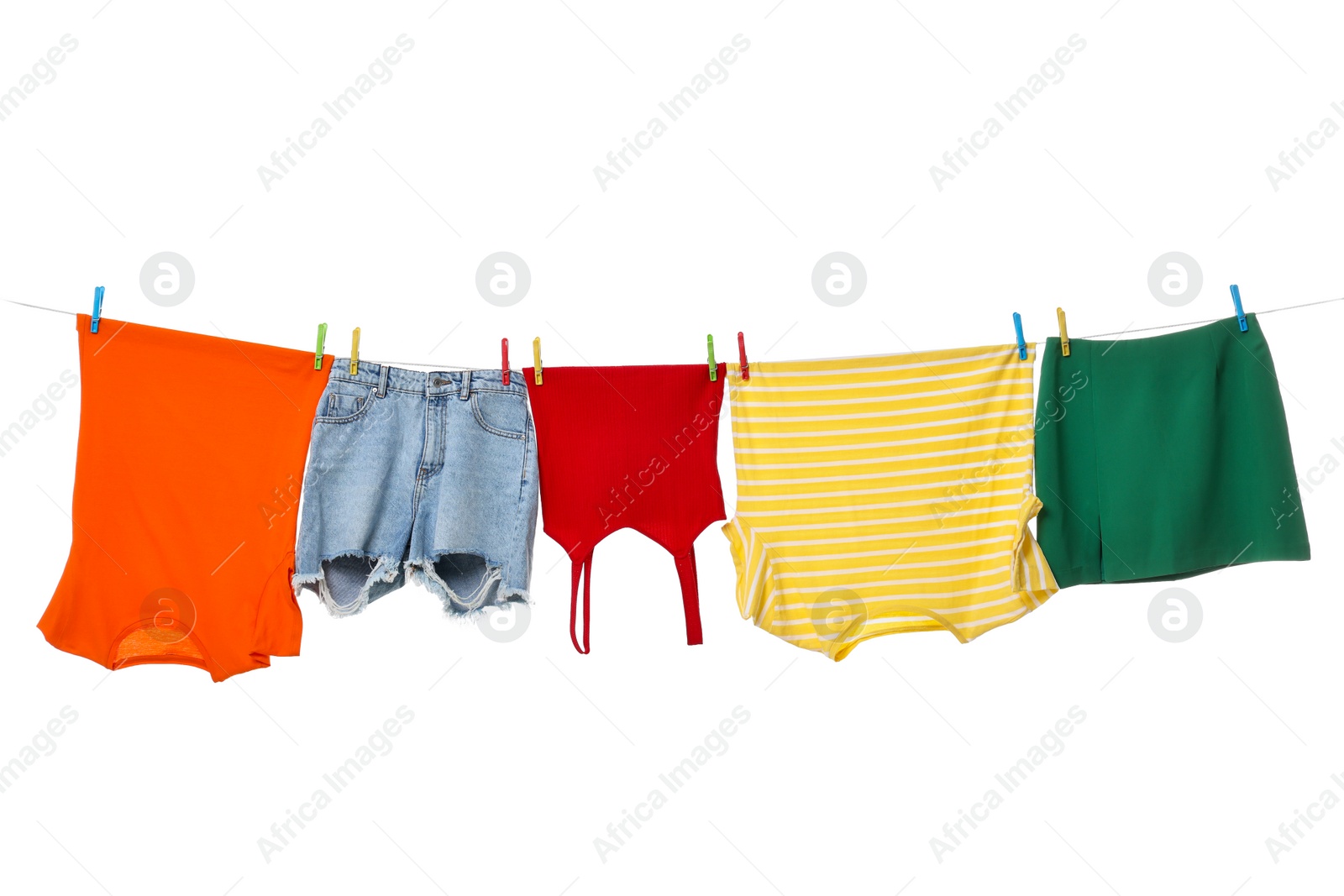 Photo of Different clothes drying on laundry line against white background