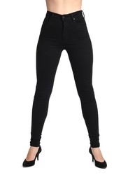 Photo of Woman wearing stylish black jeans and high heels shoes on white background, closeup