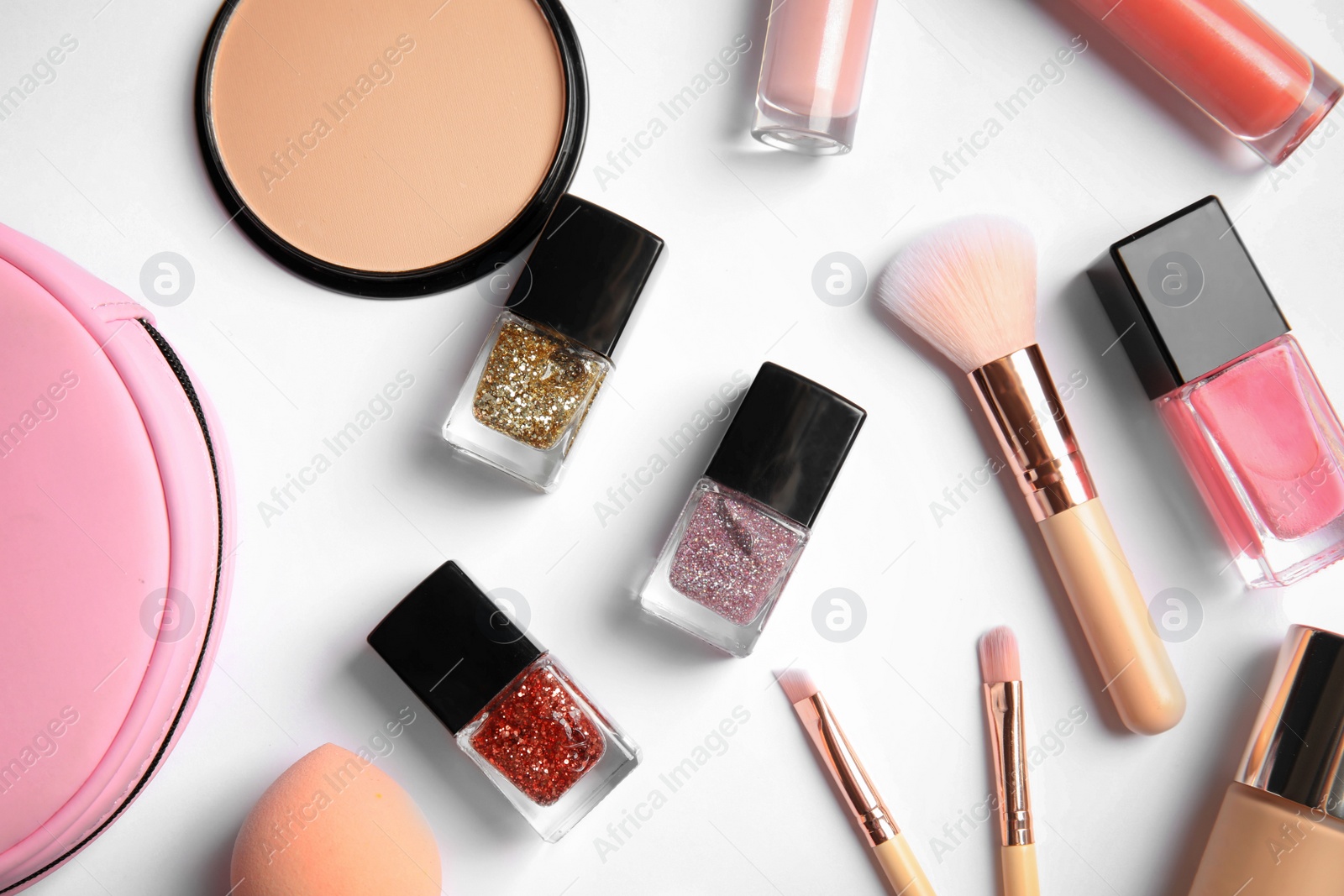 Photo of Flat lay composition with bottles of nail polish and different cosmetics on white background
