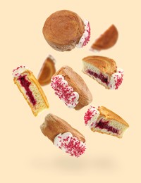 Image of Delicious round croissants in air on beige background. Puff pastry