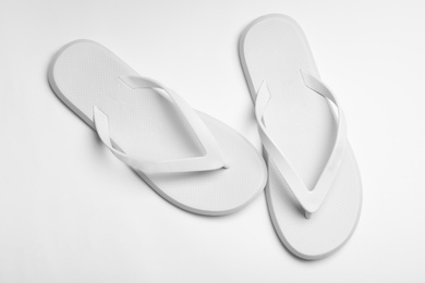 Photo of Pair of flip flops on white background, top view. Beach accessories