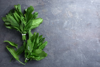Photo of Fresh green sorrel leaves on grey table, flat lay. Space for text