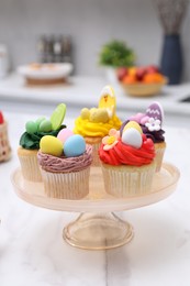 Photo of Tasty cupcakes with Easter decor on white marble table