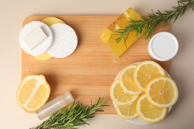 Photo of Lemon face cleanser. Fresh citrus fruits, rosemary and personal care products on beige background, flat lay