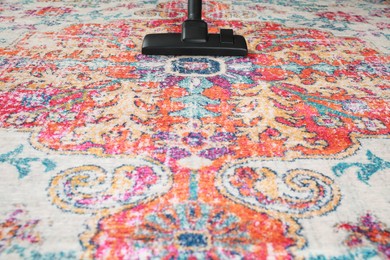 Photo of Removing dirt from carpet with modern vacuum cleaner. Space for text