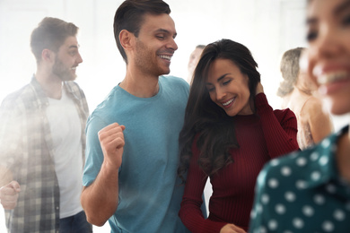 Photo of Lovely young couple dancing together at party