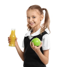 Photo of Happy girl holding apple and bottle of juice on white background. Healthy food for school lunch