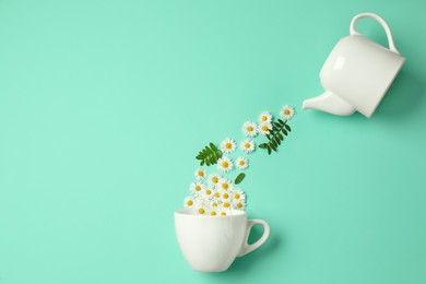 Photo of Flat lay composition with beautiful daisy flowers, leaves, ceramic cup and teapot on turquoise background