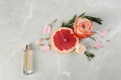 Photo of Flat lay composition with bottle of perfume on marble background