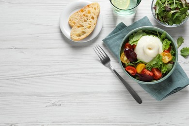 Photo of Delicious burrata salad with colorful cherry tomatoes and arugula served on white wooden table, flat lay. Space for text