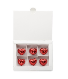 Photo of Heart shaped chocolate candies in box on white background, top view