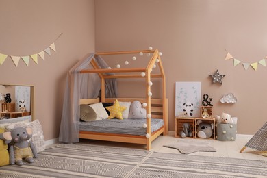 Photo of Stylish child room interior with comfortable floor bed