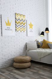 Photo of Child's room interior with bed and cute posters on wall