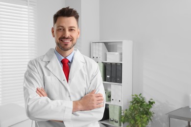 Photo of Happy doctor in clinic, space for text. Patient consultation