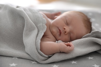 Photo of Cute little baby sleeping on bed, closeup