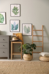 Photo of Stylish room interior with decorative ladder and monstera plant