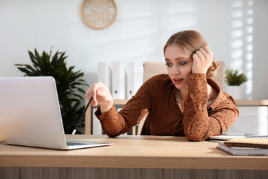 Photo of Lazy worker at wooden desk in office