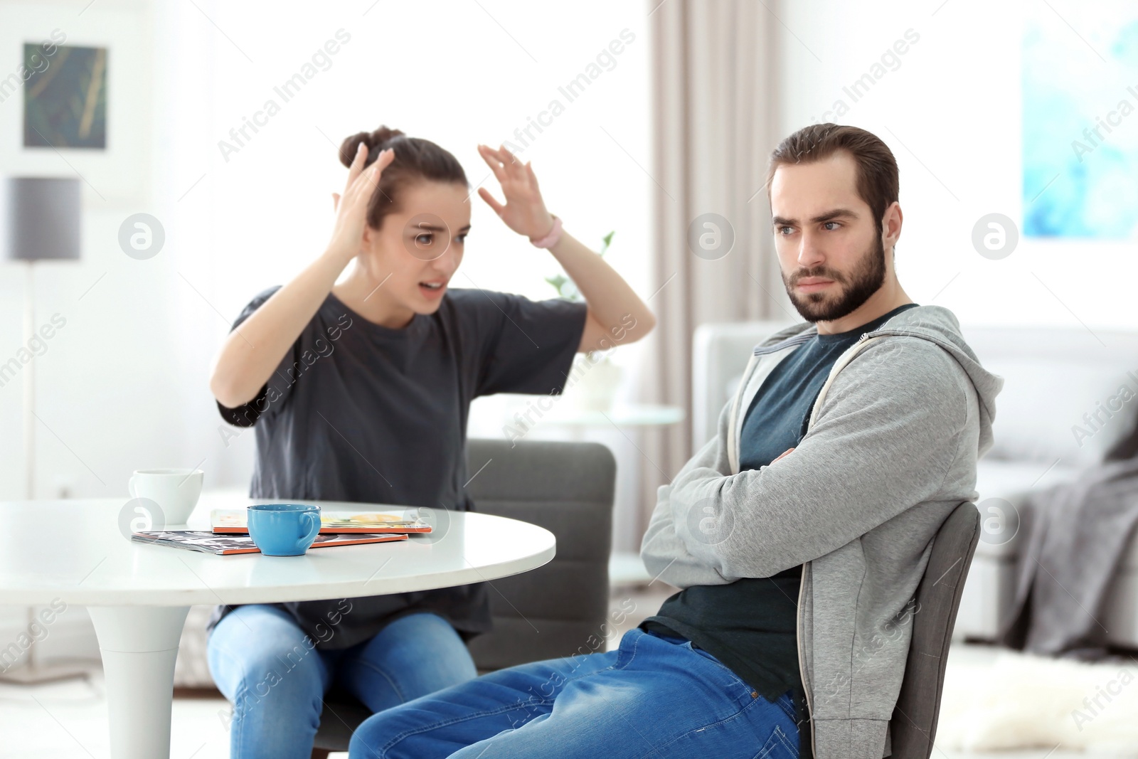 Photo of Young couple having argument at home