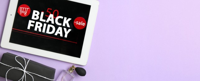 Image of Tablet with Black Friday announcement, gifts and perfumes on violet background, flat lay with space for text. Banner design