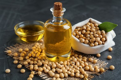 Photo of Composition with soybean oil on grey table