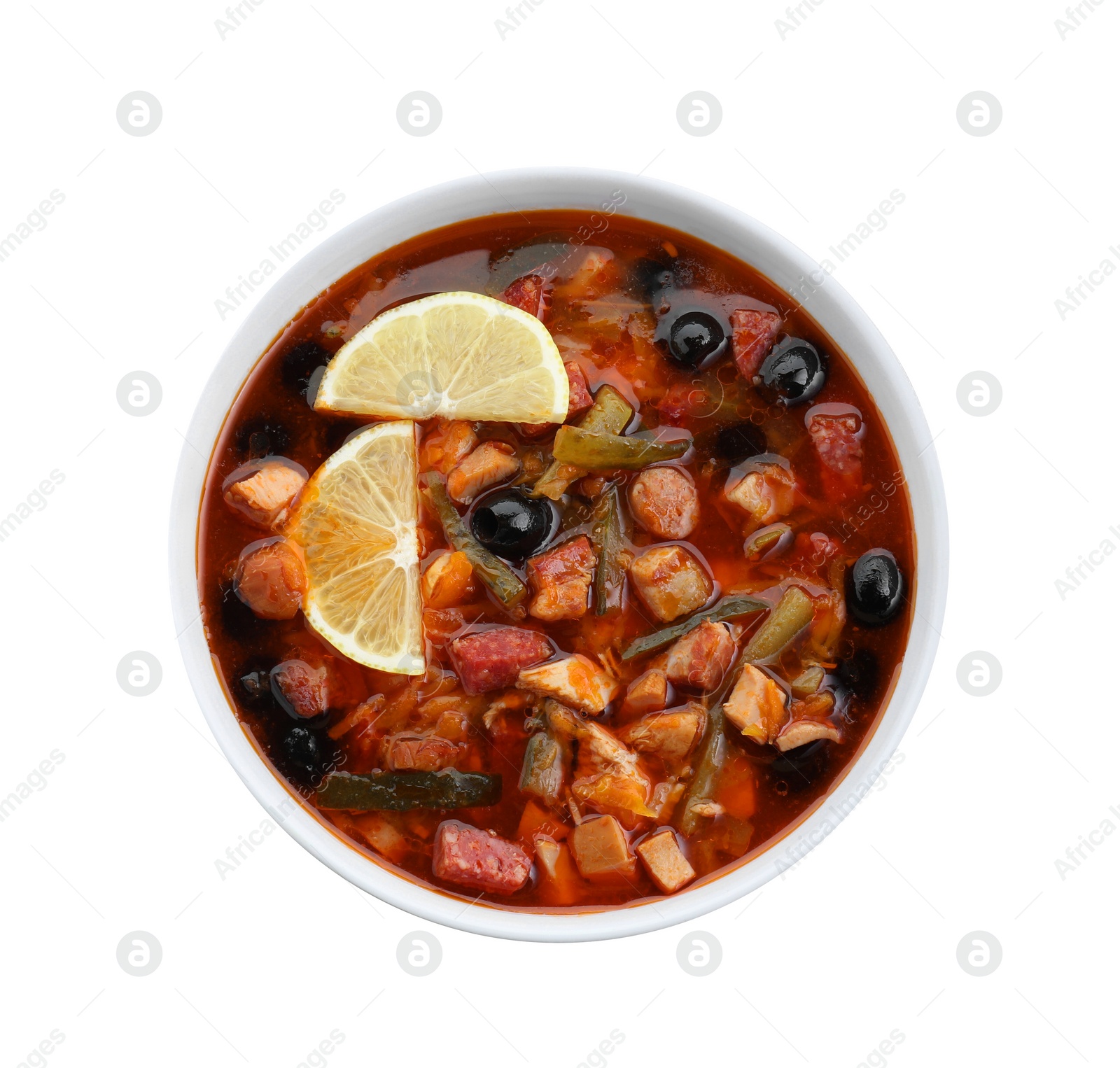 Photo of Meat solyanka soup with sausages, olives and vegetables in bowl isolated on white, top view