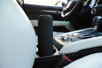 Photo of Black thermos in holder inside of car